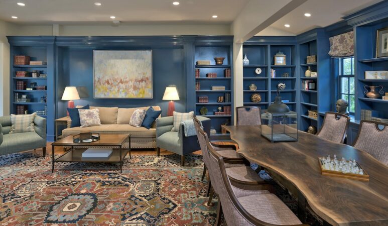 Farm House living room and dining room with blue walls with bookcases