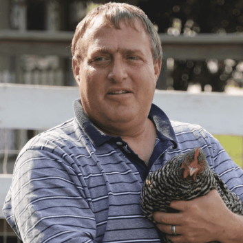Joel holding a black and white chicken