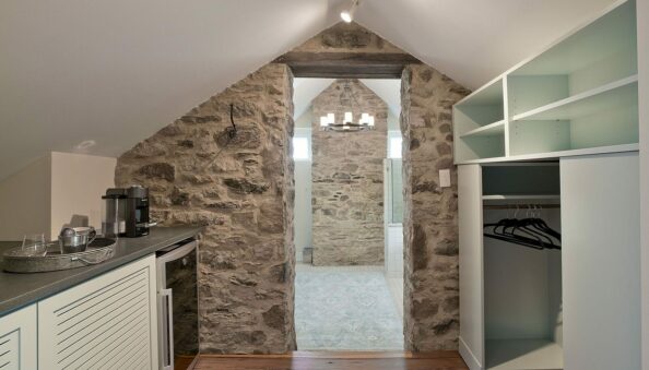 kitchen and closet area with stone wall